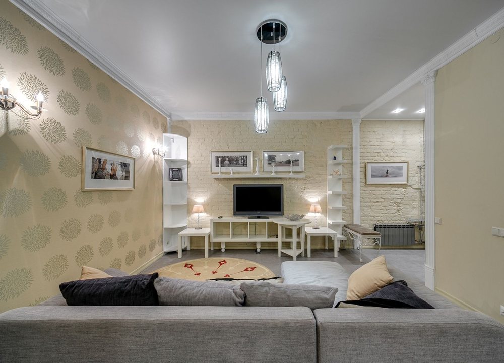 Living room with soft damask-patterned wallpaper and framed prints